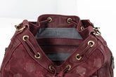 Maroon leather bag with gold accents on a white background