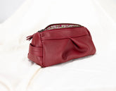 Red leather pouch with a zipper on a white background