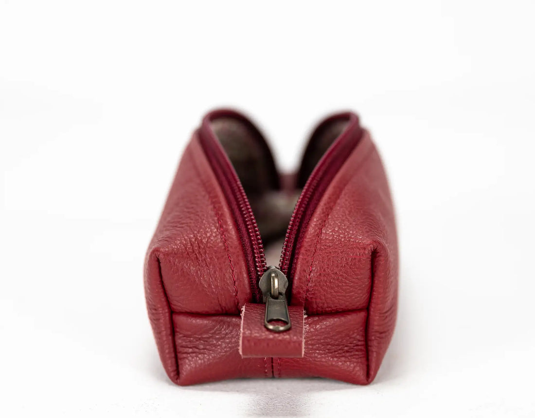Red leather pouch with a zipper on a white background