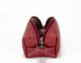 Red leather pouch with a zipper on a white background
