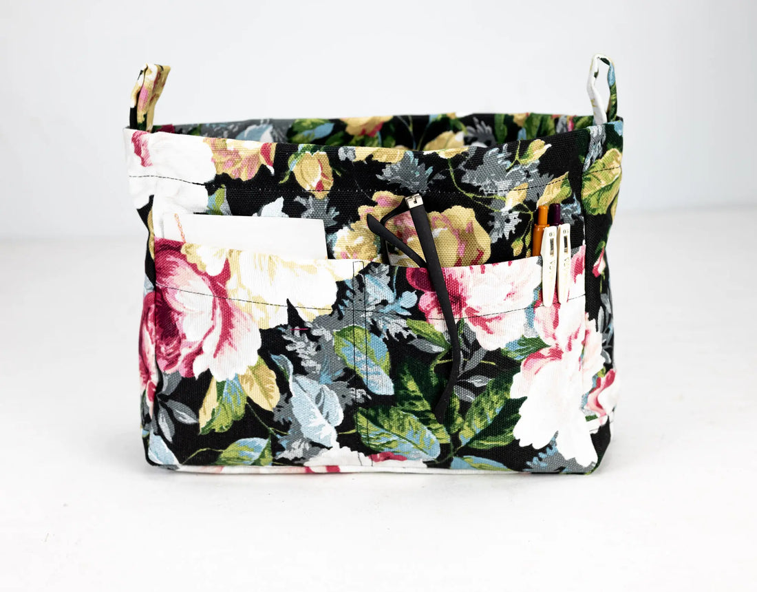 Floral-patterned bag with multiple pockets on a white background