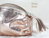 Rose gold pouch with tassel on a light background