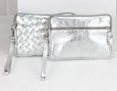 Two silver metallic handbags on a white background