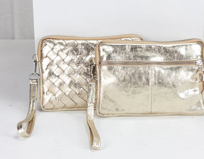 Two metallic gold handbags on a white background