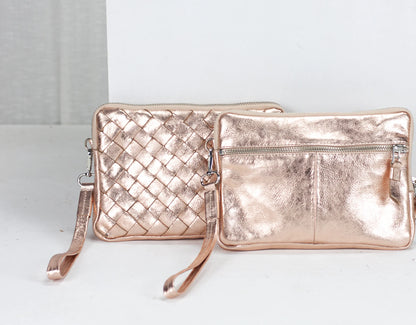Rose gold handbag and clutch on a white background