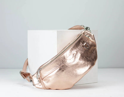 Rose gold waist bag on a white background