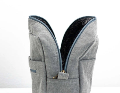 Gray backpack with blue zipper on a white background