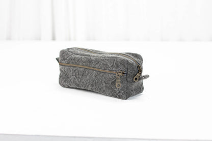Gray cotton toiletry bag with gold zipper on a white background