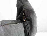 Gray bag with a zipper and gold clasp on a white background