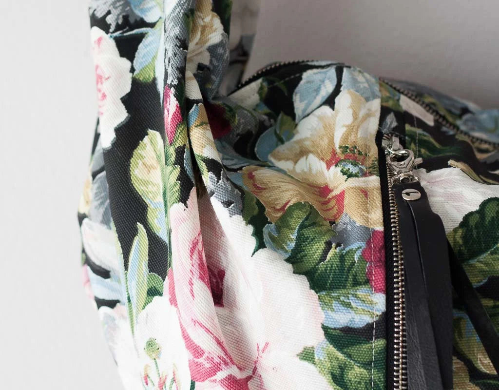 Floral patterned bag with a zipper on a light background