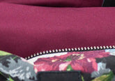 Close-up of a purple fabric with floral patterned lining and zipper