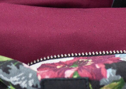 Close-up of a purple fabric with floral patterned lining and zipper