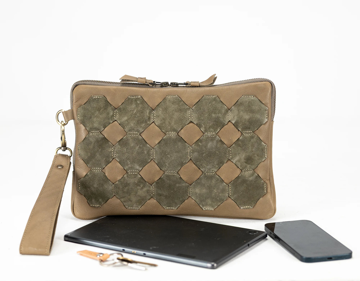 Brown clutch bag with geometric pattern, tablet, and phone on a white background