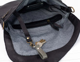 Gray and black bag with keys hanging off a strap