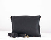 Black leather clutch bag with a strap