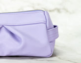 Purple pouch on a light marble background