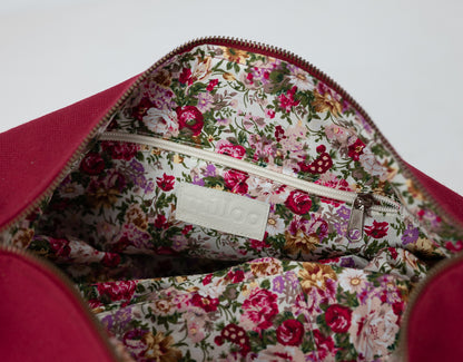 Floral-patterned interior of a bag with a visible brand label on a white background
