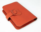 Orange leather wallet with a buckle on a white background