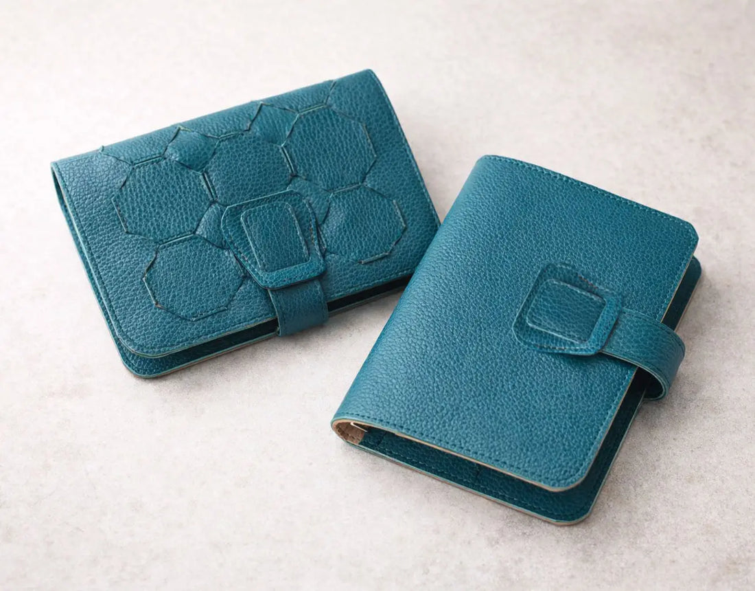 Two blue leather wallets on a light gray background