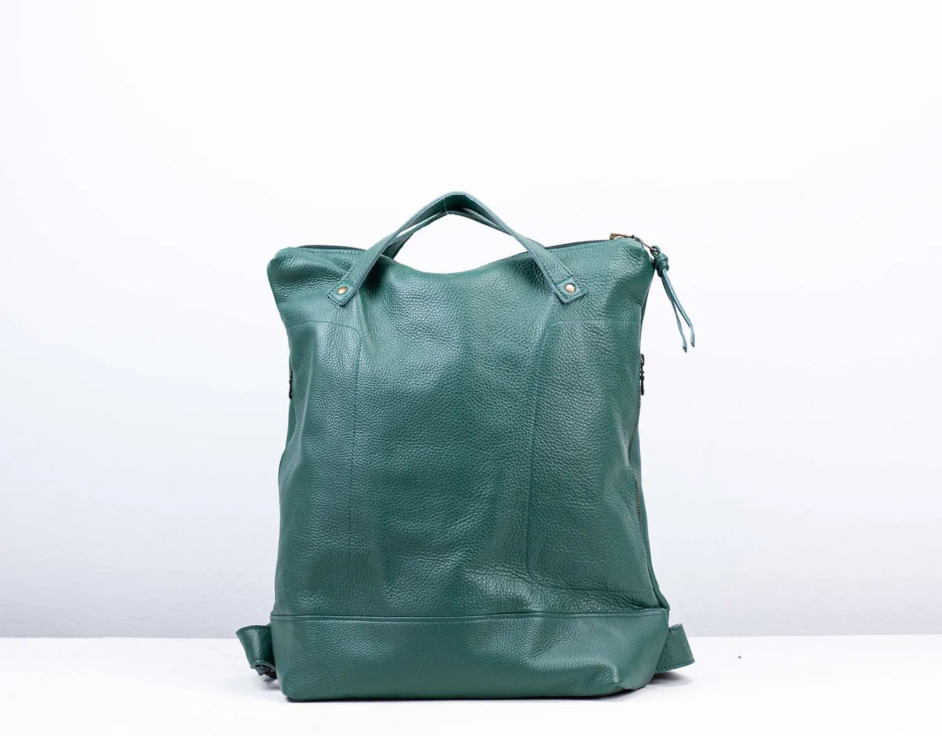 Green leather tote bag on a white background