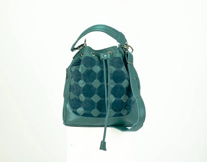 Teal patterned handbag on a white background