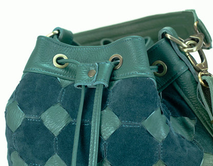 Teal textured drawstring bag with gold accents on a white background