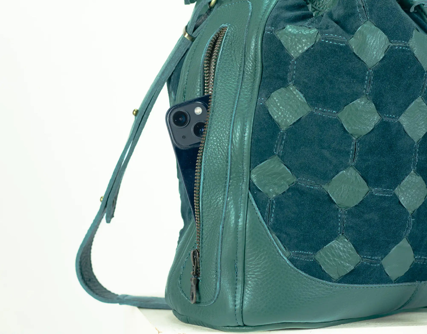 Teal quilted handbag with a visible brand logo on a white background