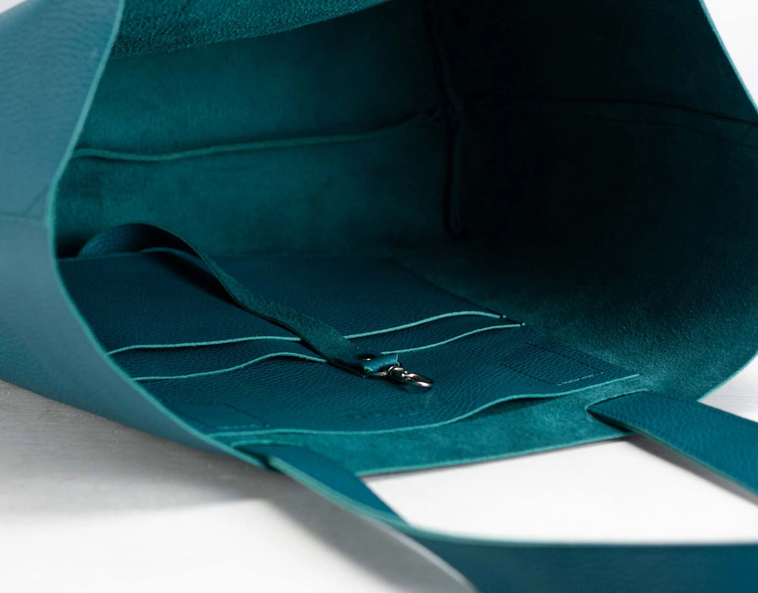 Close-up of teal leather on a white background