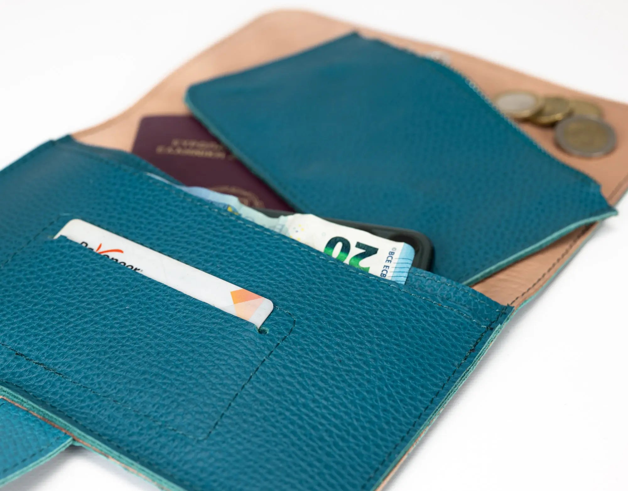 Teal leather wallet with cards and coins on a white background