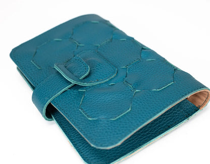 Blue textured leather wallet on a white background