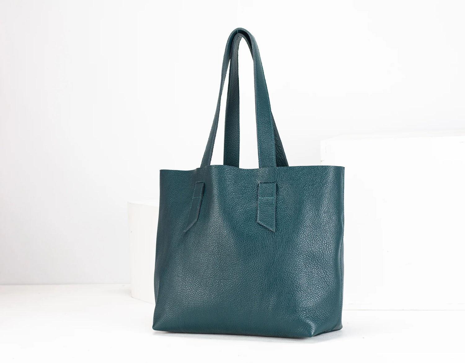Teal tote bag on a white background