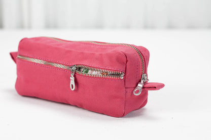 Pink cotton toiletry bag with a zipper on a white background