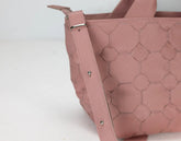 Pink textured handbag on a white background