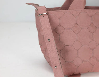 Pink textured handbag on a white background