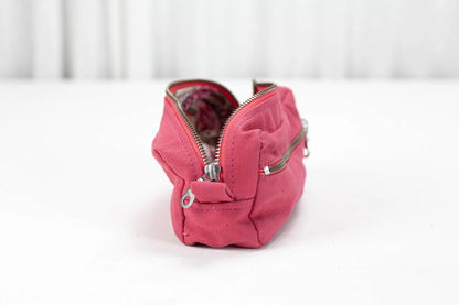 Pink zippered pouch on a white background