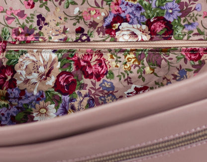 Floral-patterned fabric with a zipper on a pink background