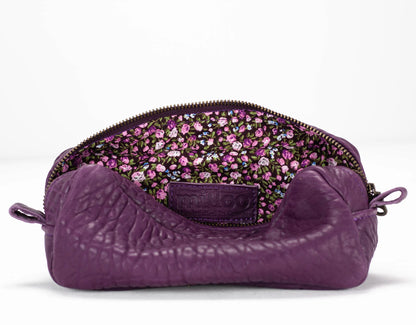 Purple textured pouch with floral patterned interior on a white background