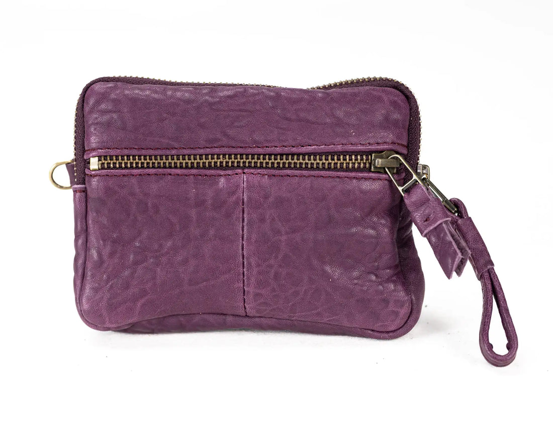 raspberry leather wallet with cards and a phone inside