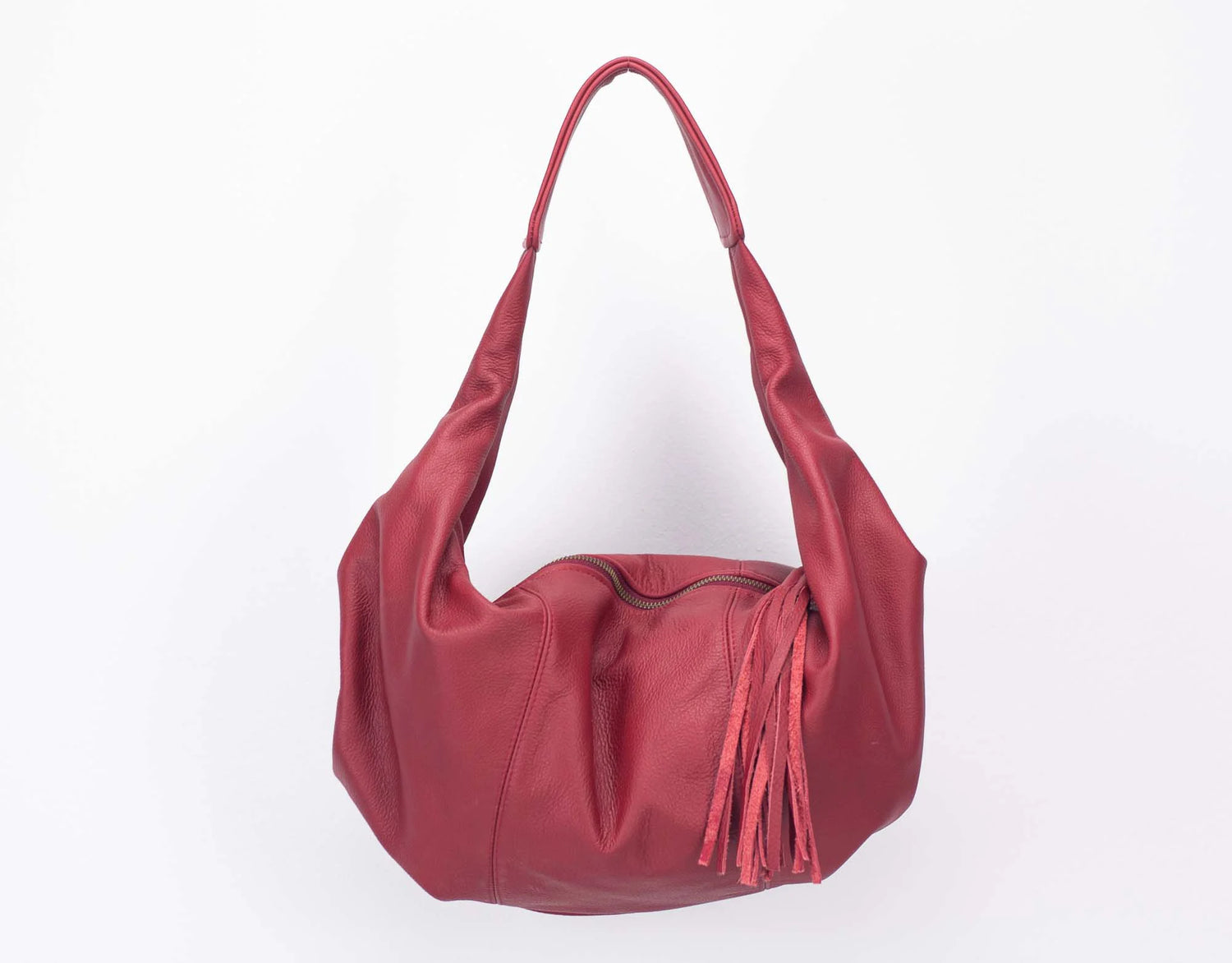 Red handbag with a tassel on a white background