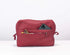 Red travel pouch with items inside on a white background