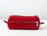 Red cotton toiletry bag with zippers on a white background