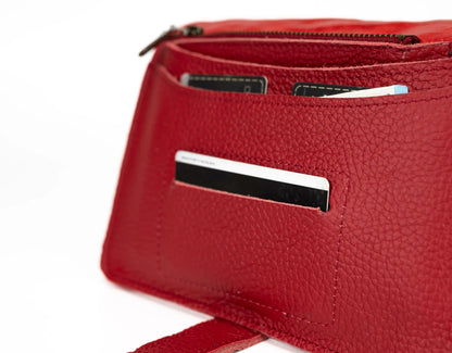 Red handbag with a strap on a white background