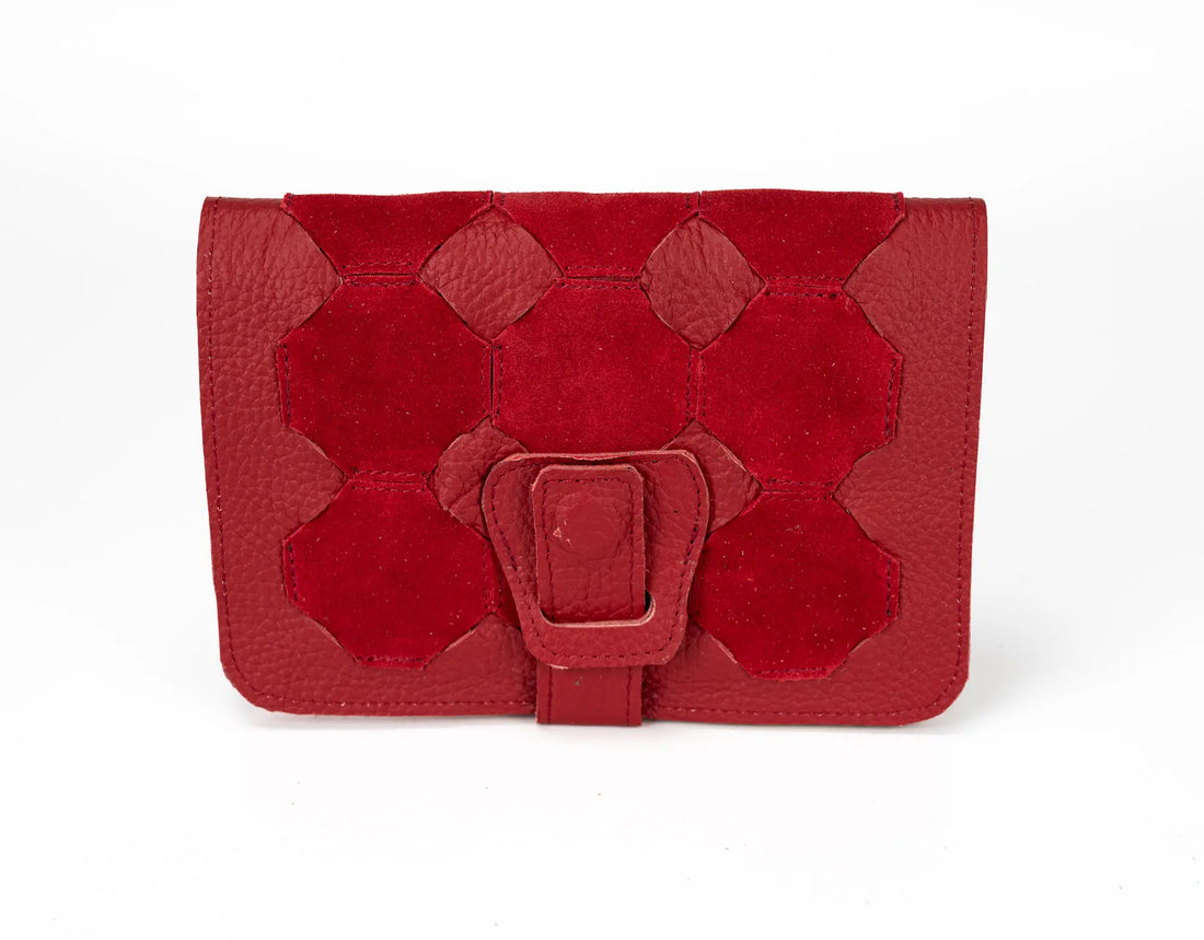 Red leather clutch with geometric design on a white background