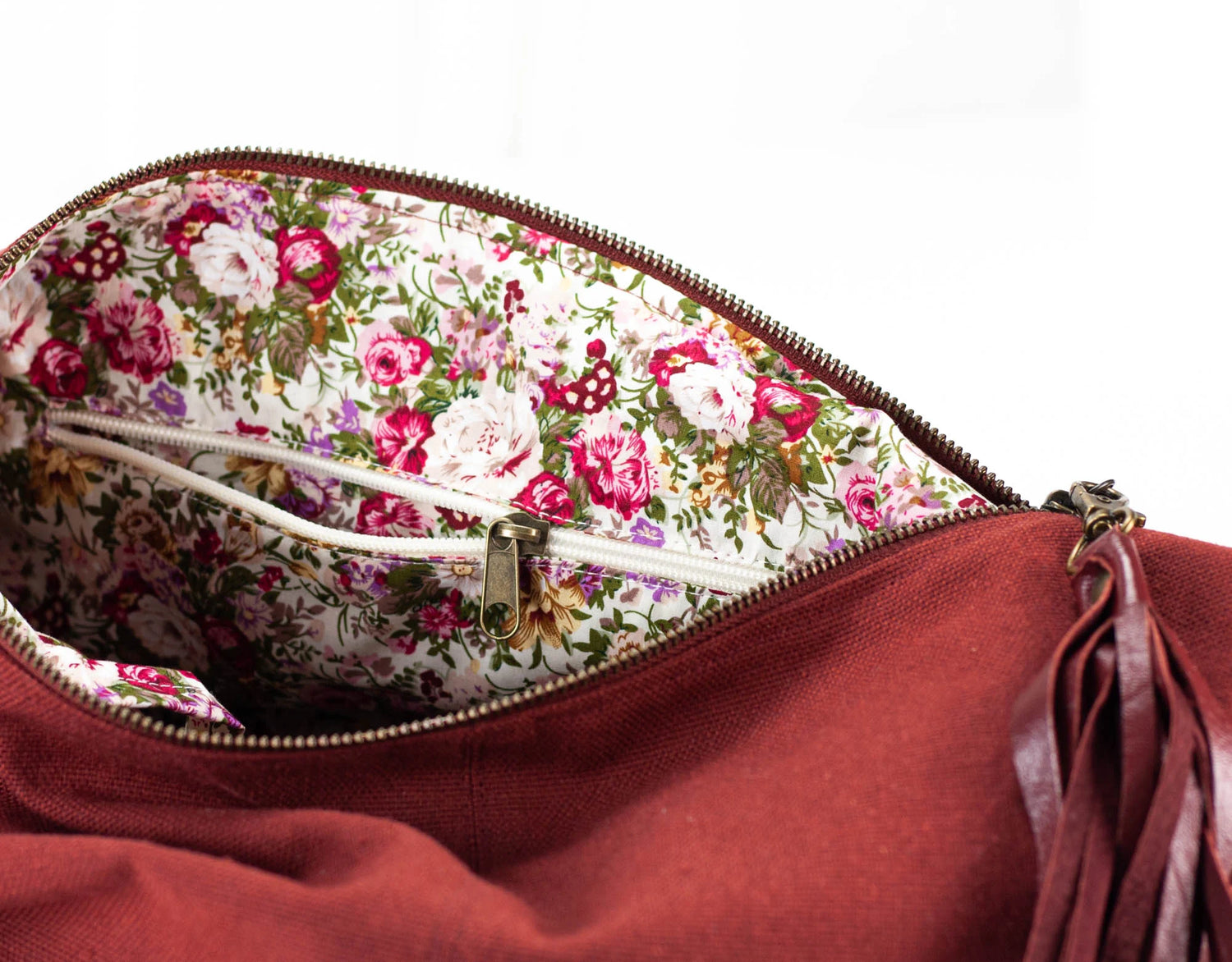 Red handbag with floral interior on a white background