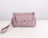 Pink handbag with a strap on a white background
