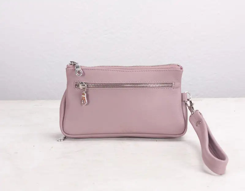 Pink handbag with a strap on a white background