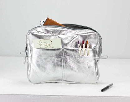 Silver pouch with a brand logo on a white background