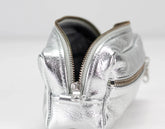 Silver metallic pouch with a zipper on a white background