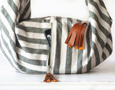 Striped bag with leather tassels on a white background