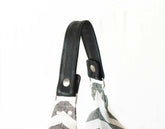 Black strap with metal buckles on a white background
